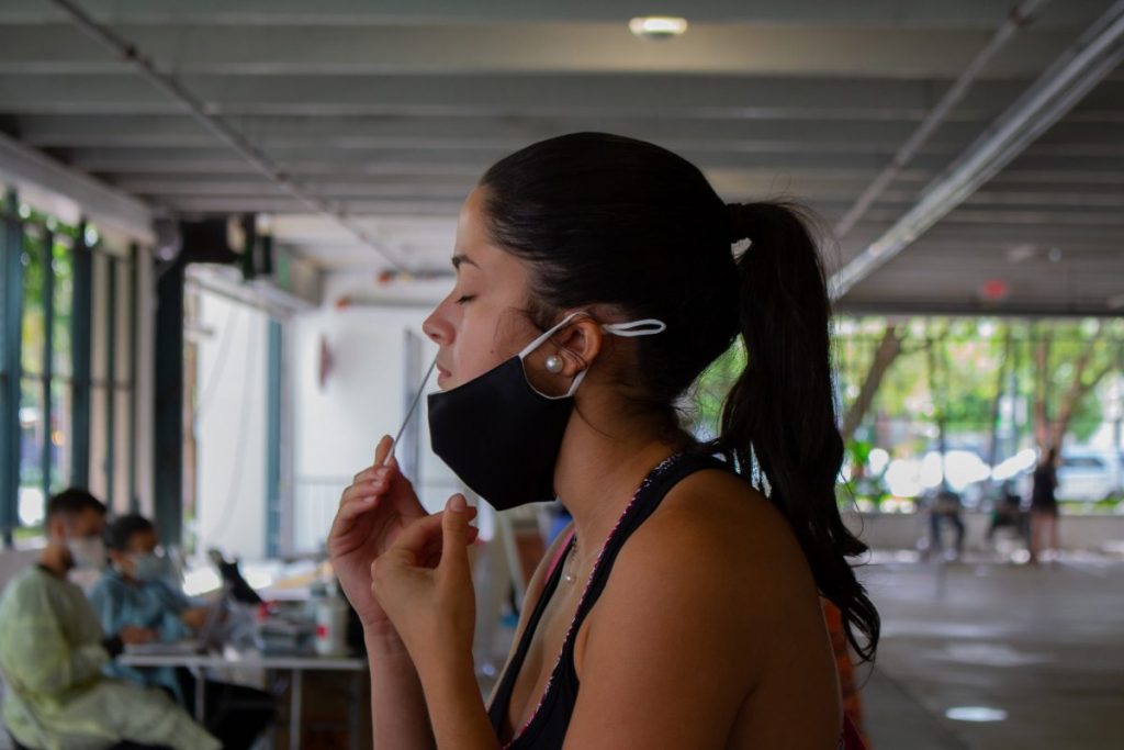 Senior Cassandra Garcia swabs her nose for a Covid-19 test in Pavia Garage on Sept. 22, 2020.