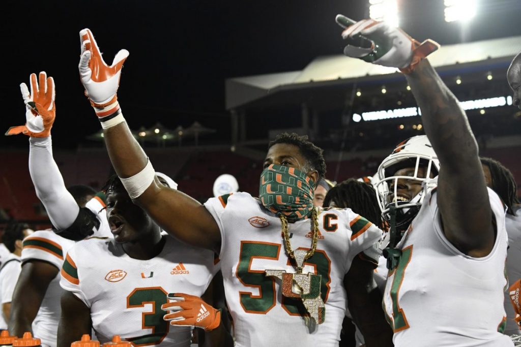 Sep 19, 2020; Louisville, Kentucky, USA;  Miami Hurricanes linebacker Zach McCloud (53) celebrates with the turnover chain during the second half of play against the Louisville Cardinals at Cardinal Stadium. Miami defeated Louisville 47-34. Jamie Rhodes-ACC Pool