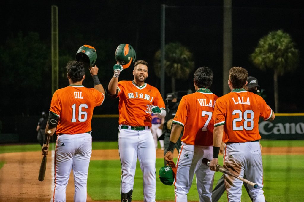 Alex Toral (30) celebrates with his teammates at home plate after blasting his second home run of the game in the bottom of the fifth inning.