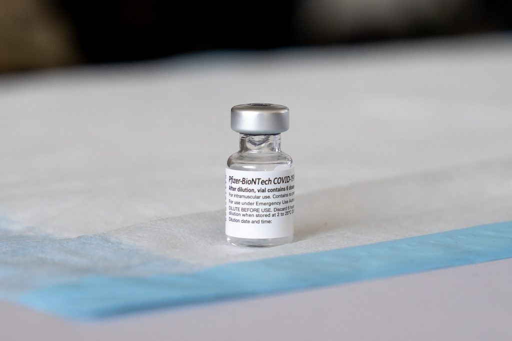 A vial of the Pfizer-BioNTech Covid-19 vaccine sits on a table in the vaccination tent at the FEMA Miami Dade College North Campus vaccination site on March 21, 2021.
