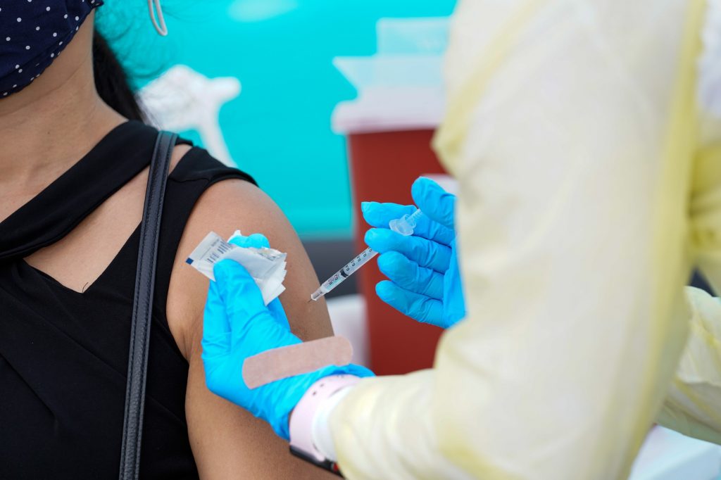Jennifer Liu receives a dose of the Johnson & Johnson COVID-19 vaccine at a county-supported pop-up site at Homestead Air Reserve Park on March 31.