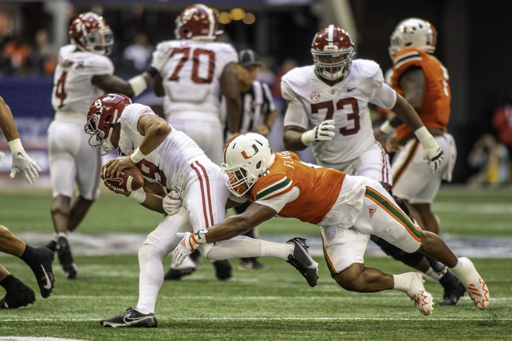 Linebacker Corey Flagg, Jr. tackles an Alabama player in the first half of Miami's game against the Crimson Tide at Mercedes-Benz Stadium in Atlanta.