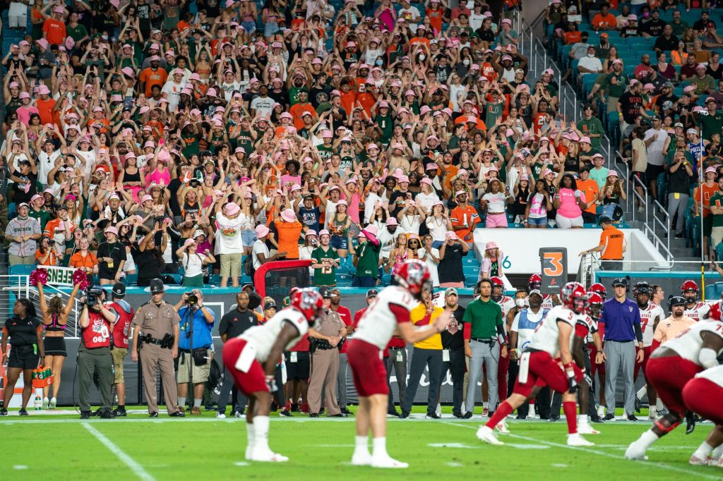 Canes fans in the student throw up the U, as a part of a third-down tradition designed to pressure and distract the opposing team’s offense, during the first quarter of Miami’s game versus NC State University at Hard Rock Stadium on Oct. 23, 2021.
