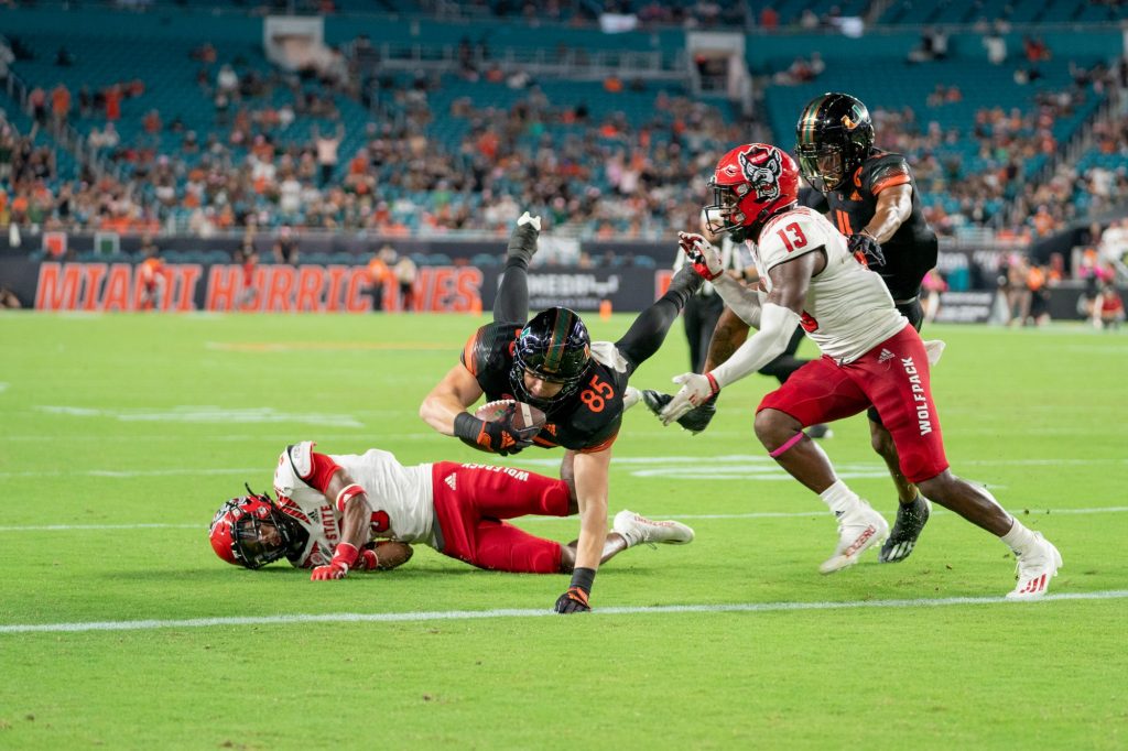 Junior tight end Will Mallory dives into the end zone and scores a touchdown in the third quarter of Miami’s game versus NC State at Hard Rock Stadium on Oct. 23, 2021.