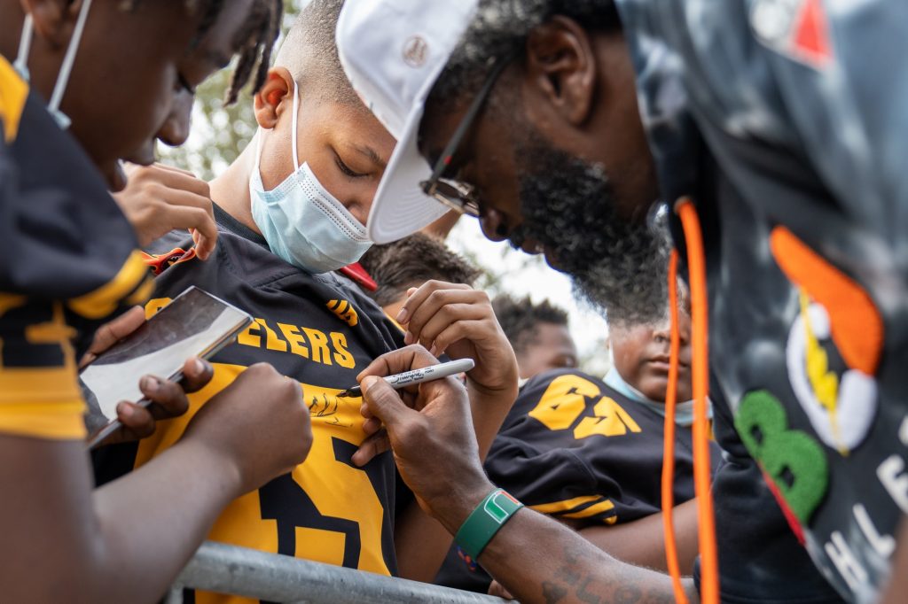 Football chief of staff and national champion Ed Reed signs autographs before the hurricane walk prior to Miami’s game versus NC State University at Hard Rock Stadium on Oct. 23, 2021.