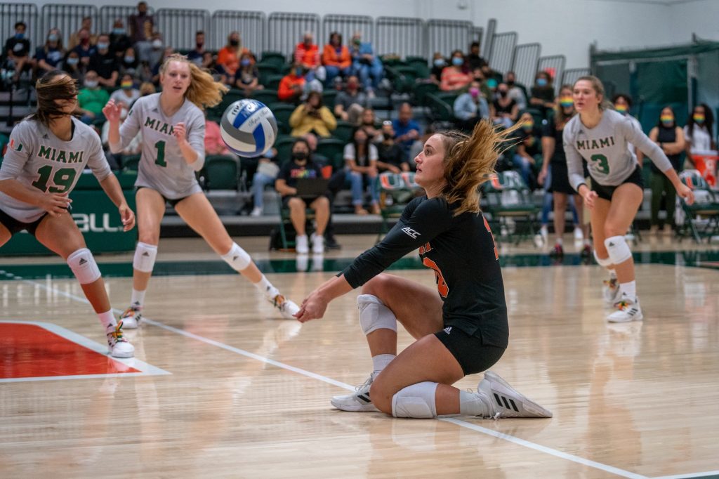 Senior defensive specialist Priscilla Hernandez kneels to bump the ball during the first set of Miami’s match versus the University of North Carolina in the Knight Sports Complex on Oct. 1, 2021.