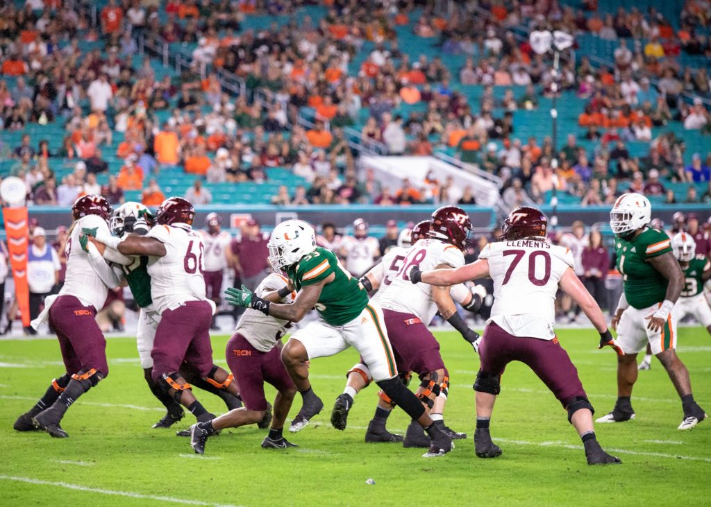 Redshirt senior defensive lineman Zach McCloud breaks through the offensive line and heads for the quarterback during the first quarter of Miami’s game versus Virginia Tech at Hard Rock Stadium on Nov. 20, 2021.
