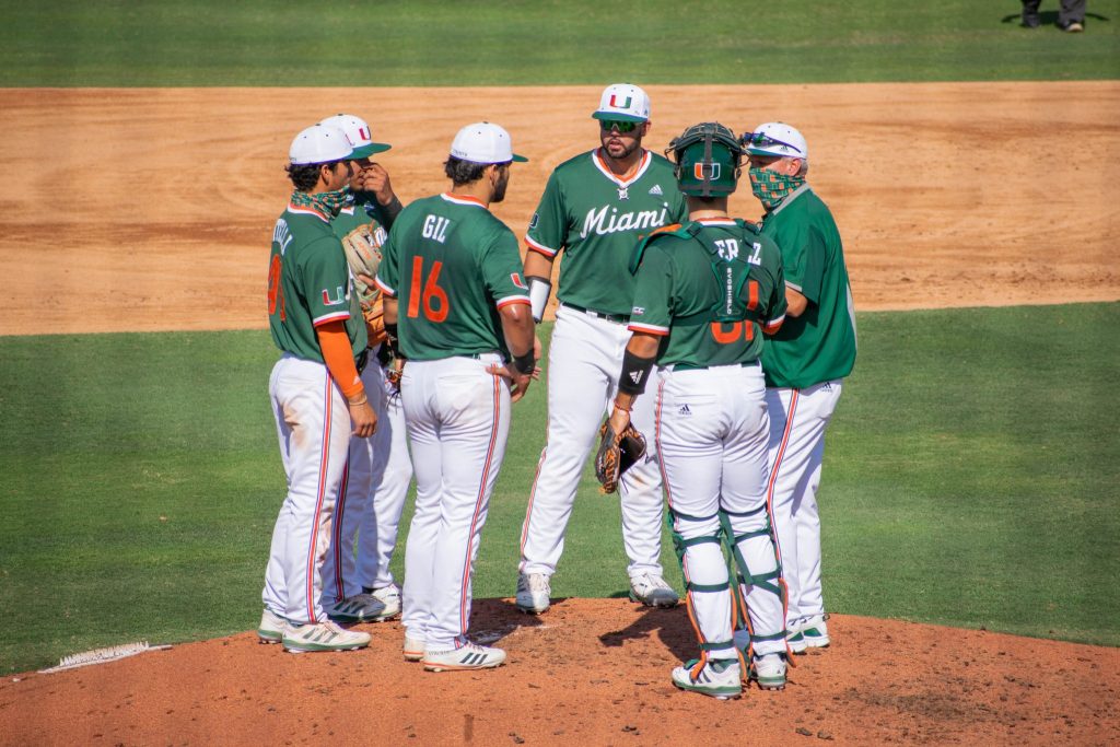The Miami Hurricanes huddle on the pitchers mound during Miami's game against Florida Gulf Coast University on April 14 at Mark Light Field.