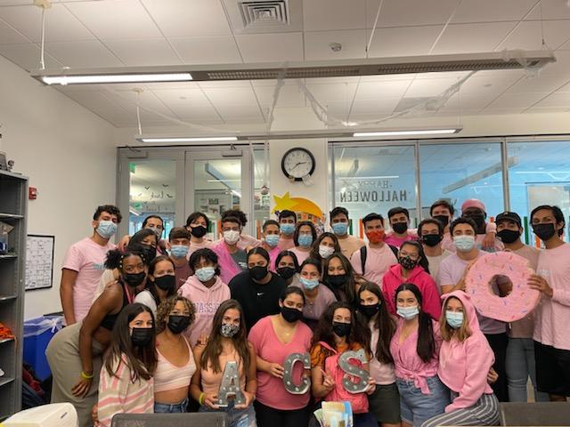 The Association of Commuter Students (ACS) pose for a photo in the Shalala Student Center. ACS raised $532.15 for Breast Cancer Awareness Month to donate to Bright Pink Foundation.