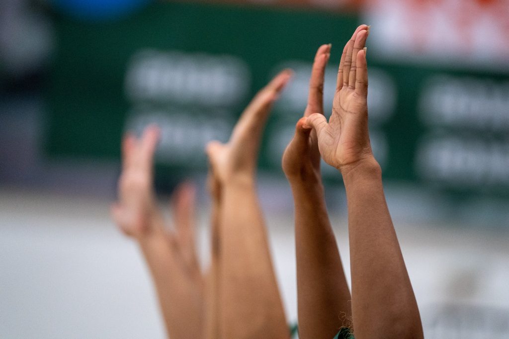 Members of UCheer hold up the U during set point in the first set of Miami’s match versus Boston College in the Knight Sports Complex on Oct. 31, 2021.
