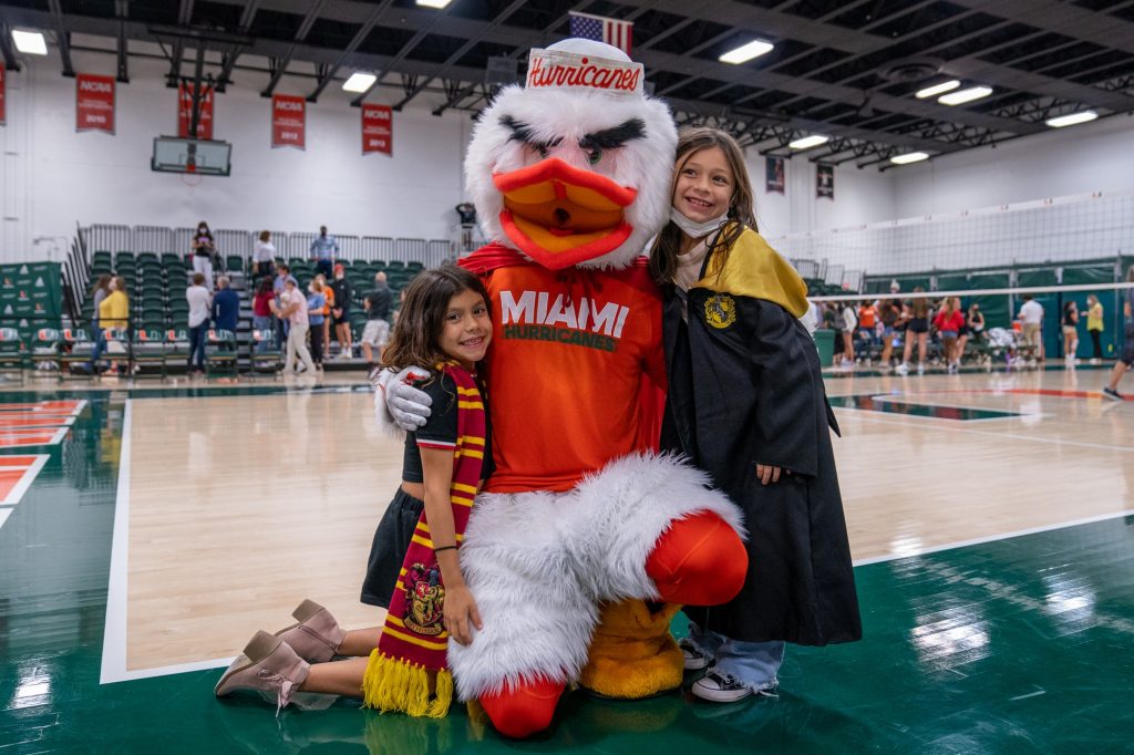 Canes fans, in costume for the Halloween-themed game, pose with Sebastian the Ibis after Miami defeated Syracuse in the Knight Sports Complex on Oct. 29, 2021.
