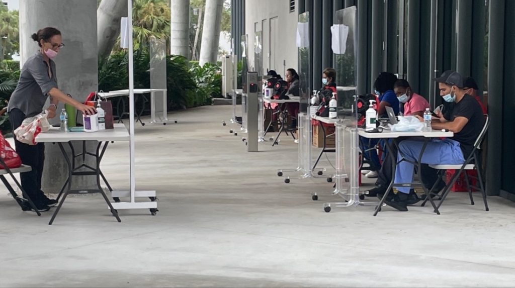 COVID-19 breath test administrators at the University of Miami administer the test outside Lobby A of Lakeside Village.