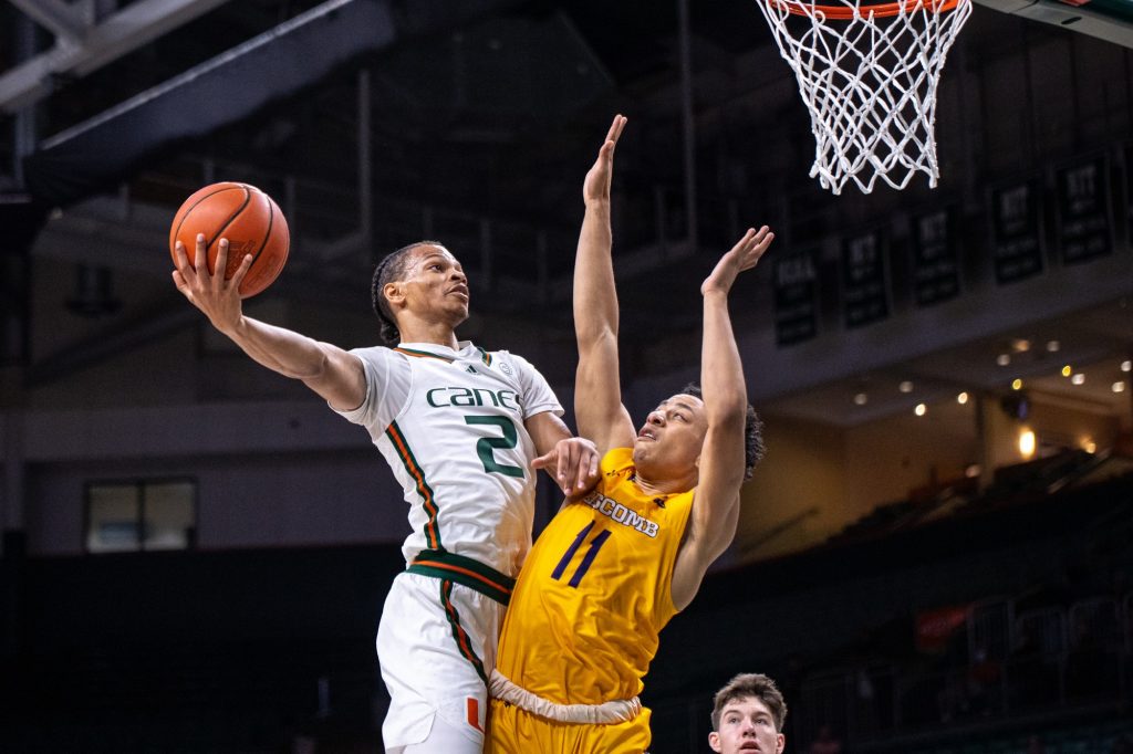 Third-year sophomore Isaiah Wong bodies a defender as he goes up for a layup during the first half of Miami's win over Lipscomb on Wednesday, Dec. 8 at the Watsco Center.