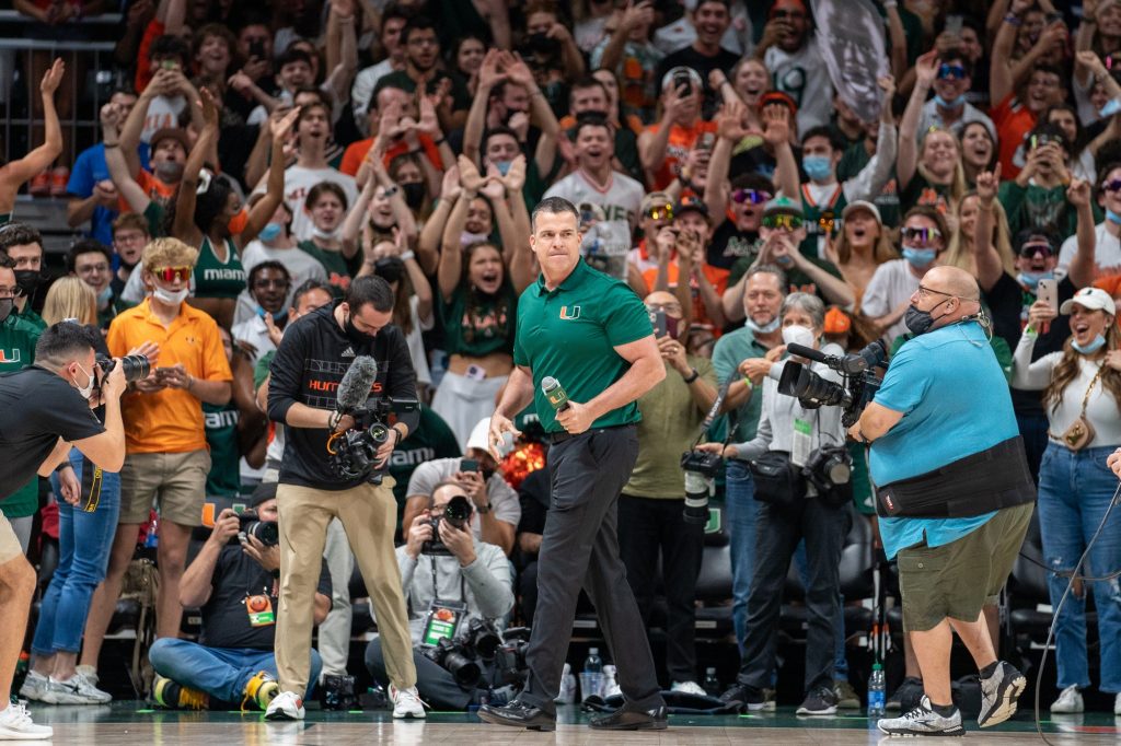 Football head coach Mario Cristobal hypes up the crowd during a timeout in the second half of Miami’s game versus Florida State in the Watsco Center on Jan. 22, 2022.