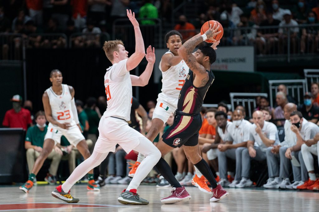 Sixth-year redshirt senior forward Sam Waardenburg and guard Charlie Moore attempt to force a turnover during the first half of Miami’s game versus Florida State in the Watsco Center on Jan. 22, 2022.
