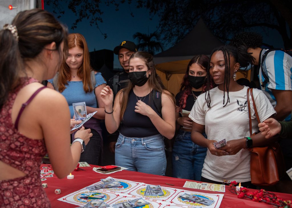 Students receive their “prize money” after playing Bầu cua tôm cá as a part of the Lunar New Year Festival on the Lakeside Patio on Feb. 7, 2022.