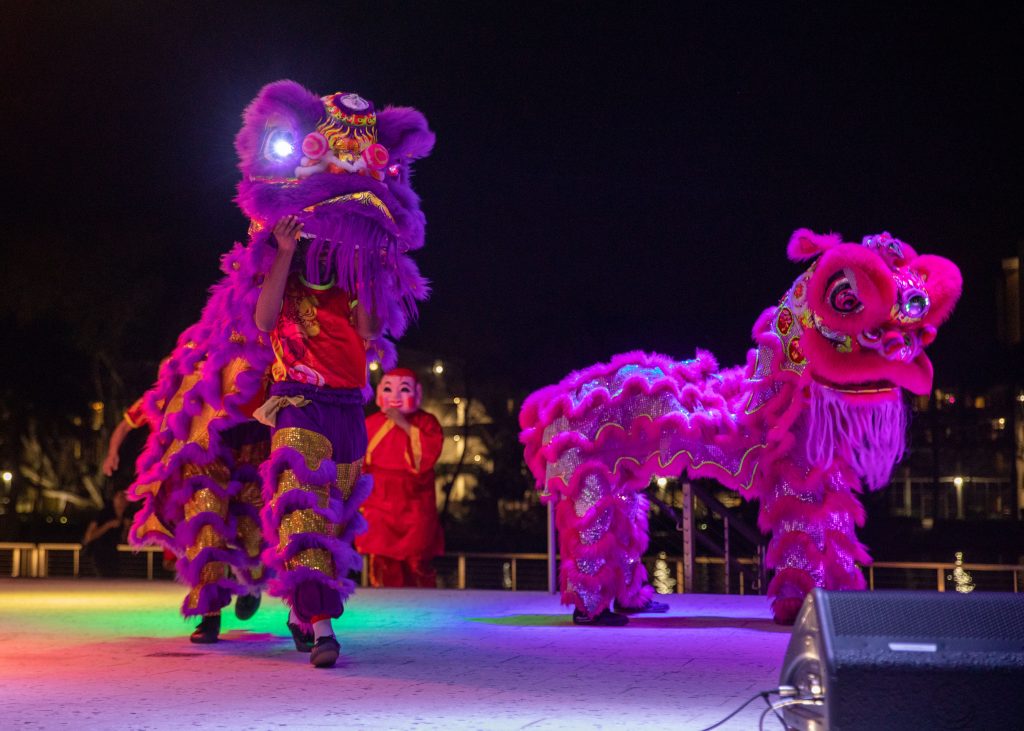 Performers are seen on stage with various costumes during the lunar new year celebration.