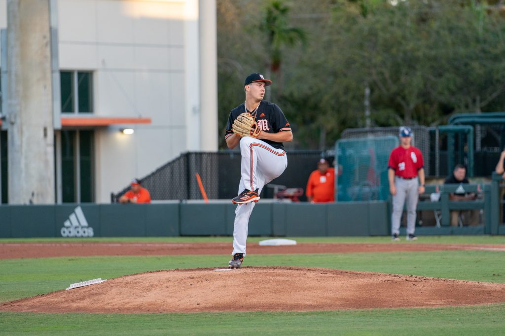 Freshman pitcher Karson Ligon winds up to pitch at the top of the first inning of Miami’s game versus FAU at Mark Light Field on Feb. 23, 2022.