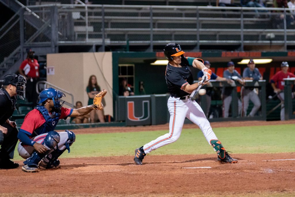 Sophomore outfielder Jacob Burke hits for a two-run base-hit in the bottom of the seventh inning of Miami’s game versus FAU at Mark Light Field on Feb. 23, 2022. Burke totaled 3 RBIs for the game.