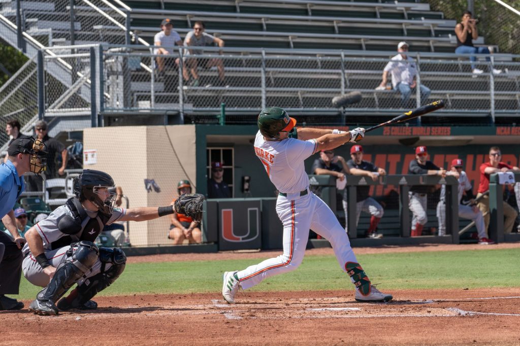 Sophomore outfielder Jacob Burke hits for a three-run home run in the bottom of the first inning of Miami’s game versus Harvard at Mark Light Field on Feb. 27, 2022. The home run brought the score to 4-0.