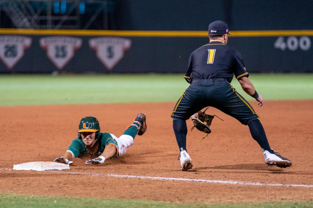 Freshman outfielder Lorenzo Carrier slides to third in the bottom of the sixth inning of Miami’s game versus Towson at Mark Light Field on Feb. 18, 2022.