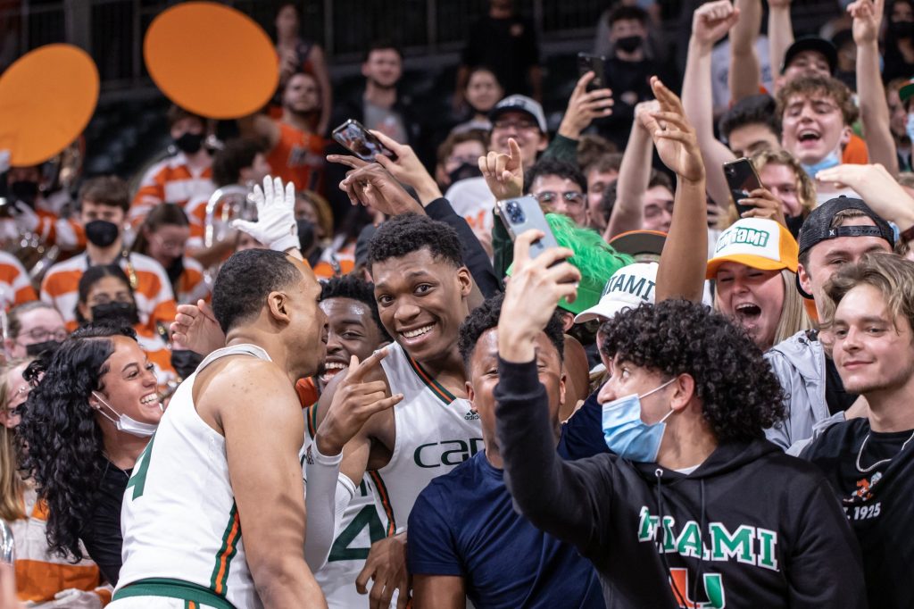 Rodney Miller Jr., Bensley Joseph and Anthony Walker celebrate with students after Miami's come back win against Georgia Tech on Wednesday, Feb. 9 at the Watsco Center. Walker, who was celebrating his birthday, scored 12 points and had eight rebounds in the win.