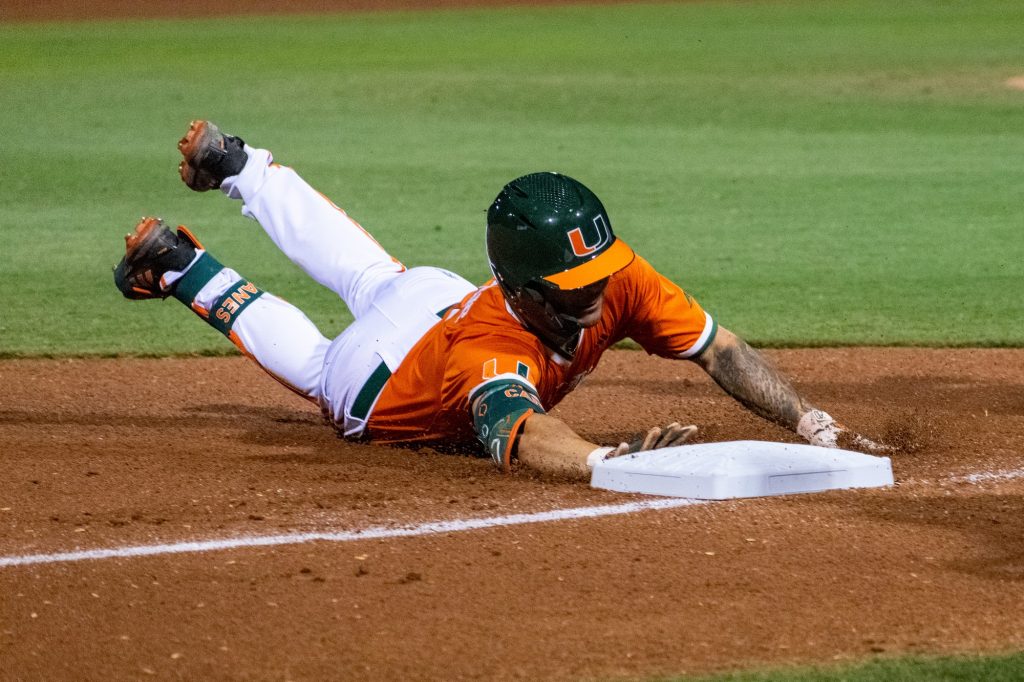 Sophomore infielder CJ Kayfus slides into third base during Miami's game against Harvard on Saturdy, February 26, 2022 at Mark Light Field.