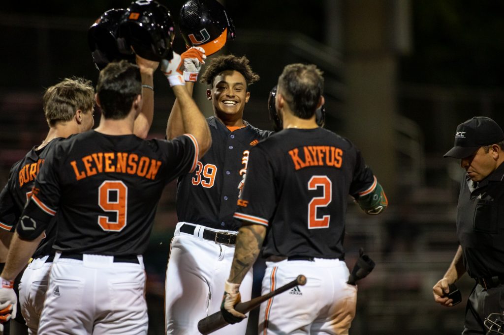 Sophomore Jacoby Long celebrates with teammates after hitting his first home run of the season in Miami's win over FAU on Wednesday, Feb. 23, 2022 at Mark Light Field.