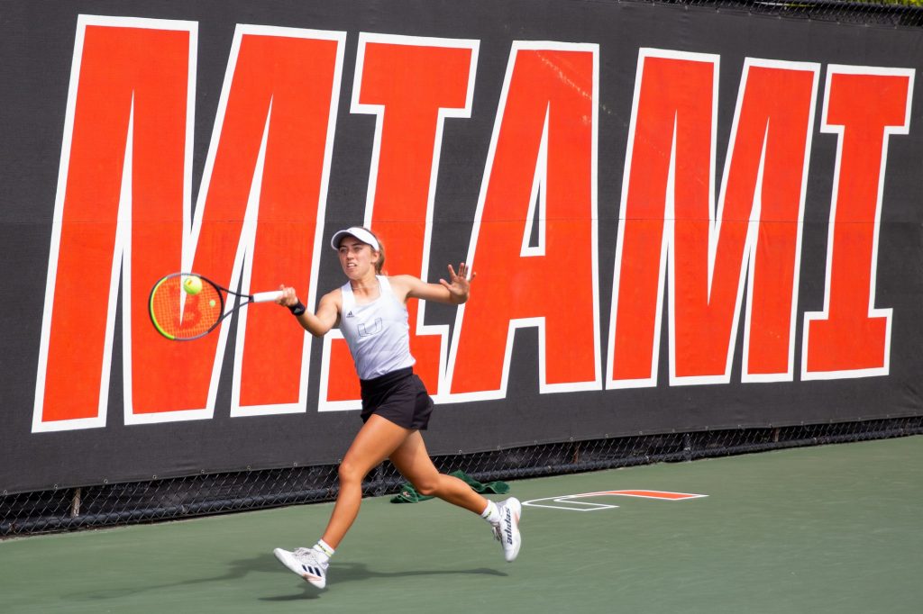 Sophomore Isabella Pfennig hits the ball during her doubles match alongside Sophomore Audrey Boch-Collins. Pfennig and Boch-Collins won their doubles match against UCF which helped Miami towards a 5-0 sweep of UCF on Sunday, Feb. 20 at the Schiff Tennis Center.