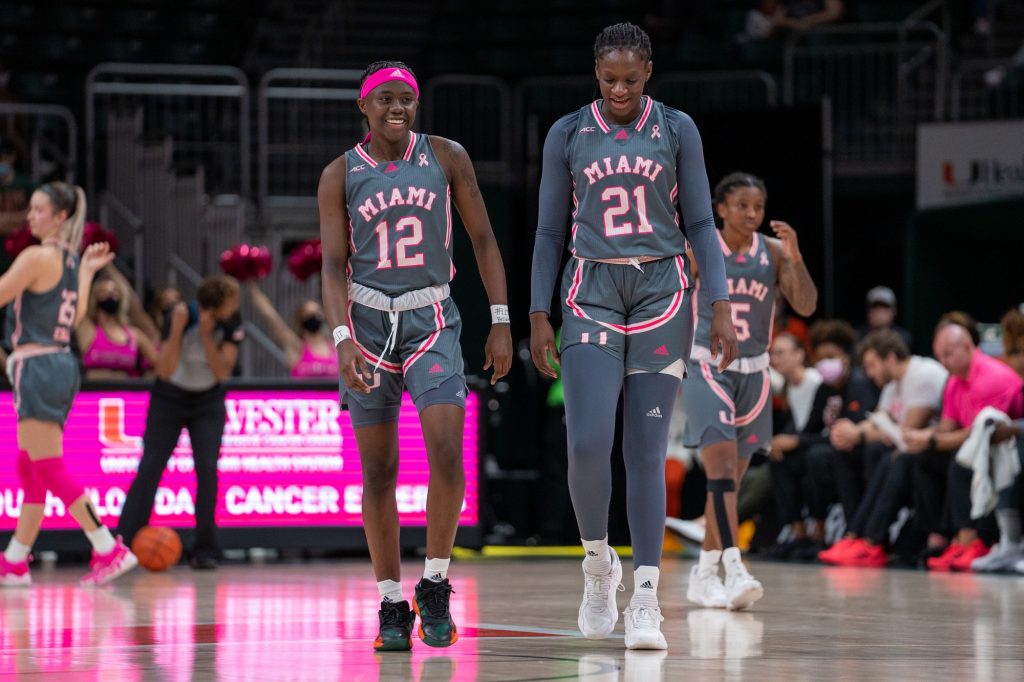 Freshman guard Ja’Leah Williams and Junior forward Lola Pendande chat at the end of a timeout in the second quarter of Miami’s game versus Florida State in The Watsco Center on Feb. 13, 2022.