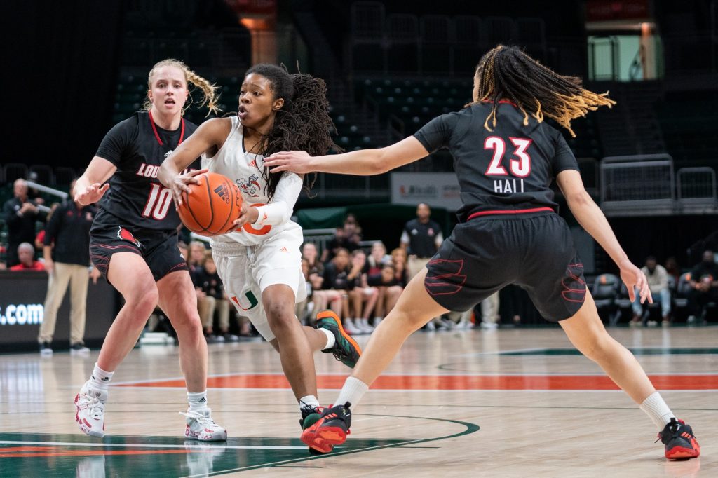 Graduate student guard Kelsey Marshall drives past defenders to the basket during the fourth quarter of Miami’s game versus Louisville in The Watsco Center on Feb. 1, 2022.