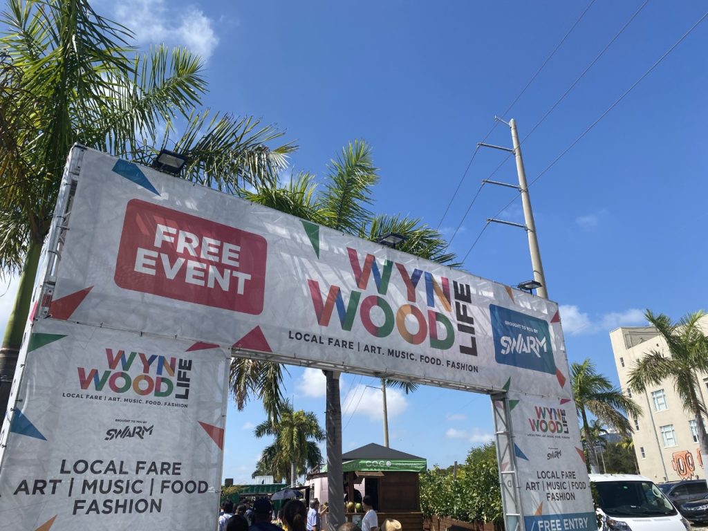 Signs are seen promoting music, food, fashion and art during Wynwood Life festival.
