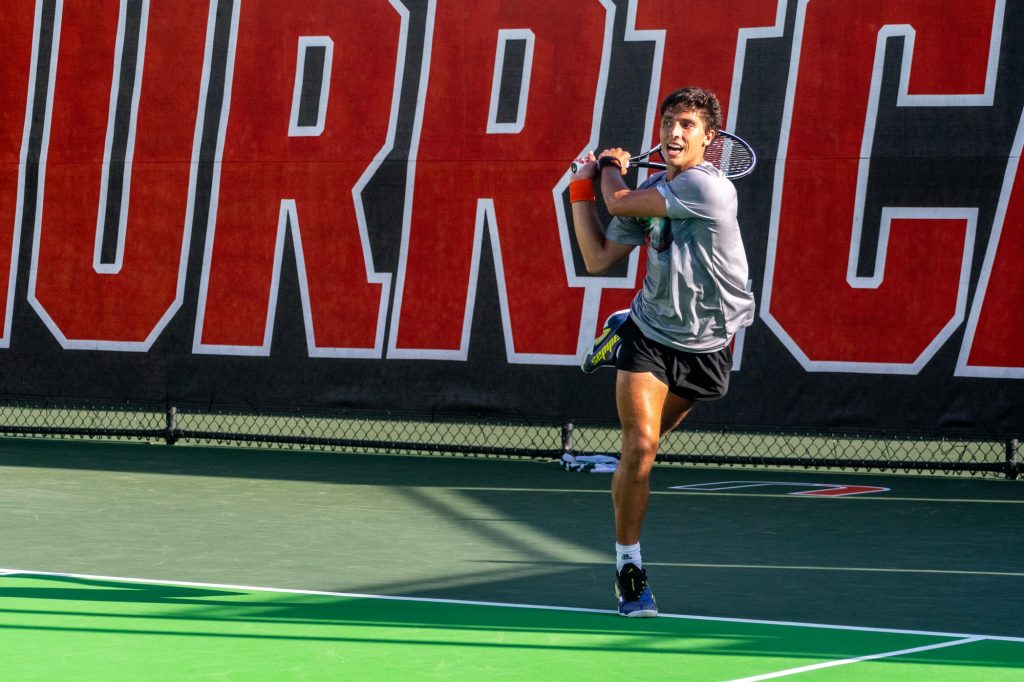 Fourth-year junior Franco Aubone returns the ball during his singles match against Army at the Neil Schiff Tennis Center on March 9, 2022.