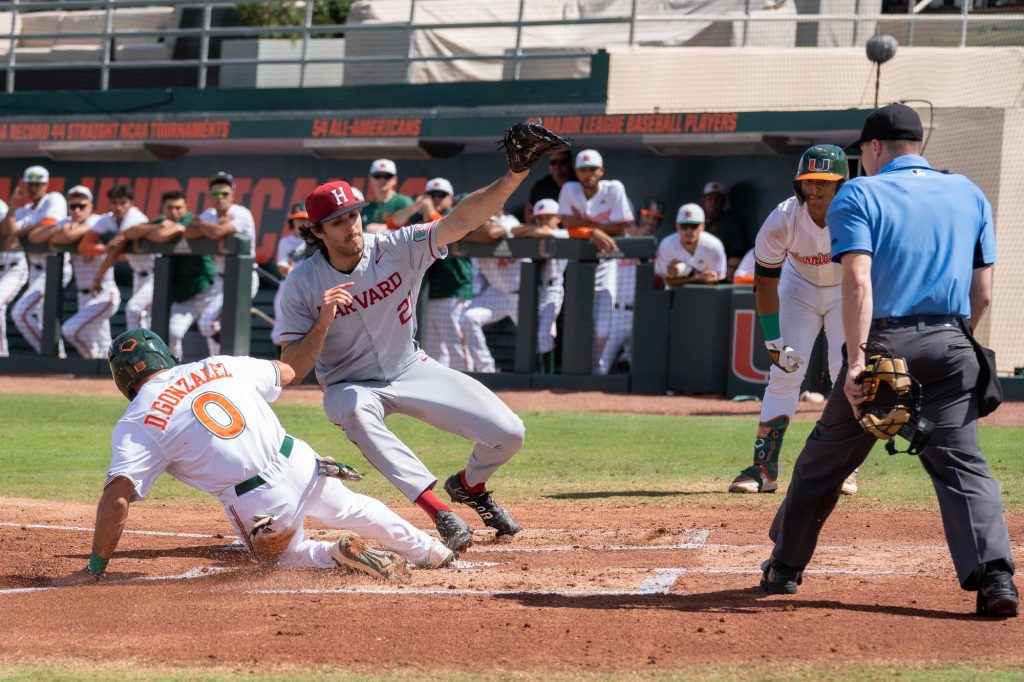 Freshman infielder Dorian Gonzalez Jr. steals home on a wild pitch in the bottom of the first inning of Miami’s game versus Harvard at Mark Light Field on Feb. 27, 2021.. The score put the Canes on the board 1-0.