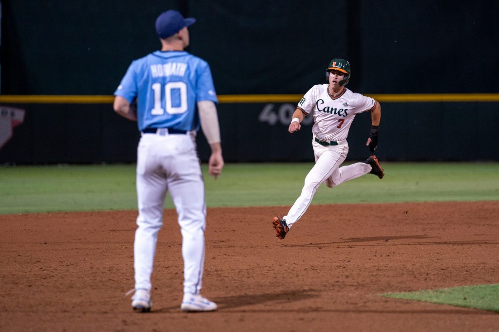 Sophomore outfielder Jacob Burke advances to third base on freshman infielder Dorian Gonzalez Jr.’s single down the right field line in the bottom of the third inning of Miami’s game versus the University of North Carolina at Chapel Hill at Mark Light Field on March. 25, 2022.