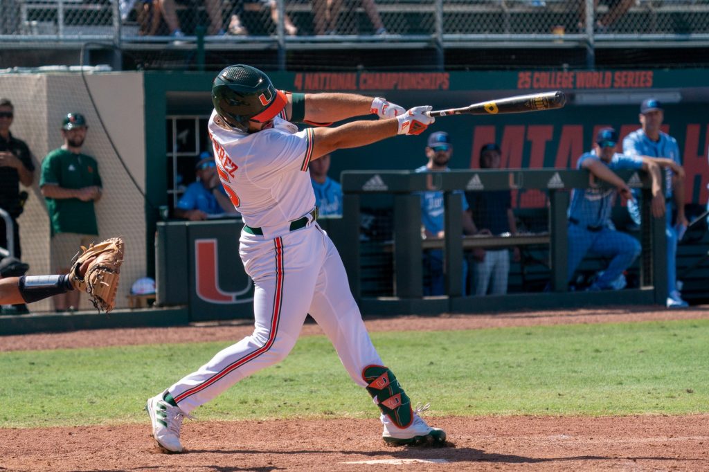 Freshman outfielder Gaby Gutierez hits in the bottom of the ninth inning of Miami’s game versus the University of North Carolina at Chapel Hill at Mark Light Field on March 27, 2022. Gutierez batted in sophomore outfielder Jacob Burke to tie 2-2, and send the game into extra innings.