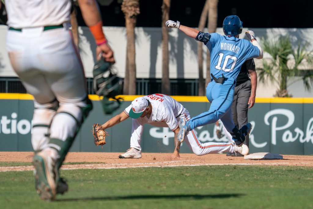 Sophomore infielder CJ Kayfus catches the throw to first for the out in the top of the fourteenth inning of Miami’s game versus the University of North Carolina at Chapel Hill at Mark Light Field on March 27, 2022.
