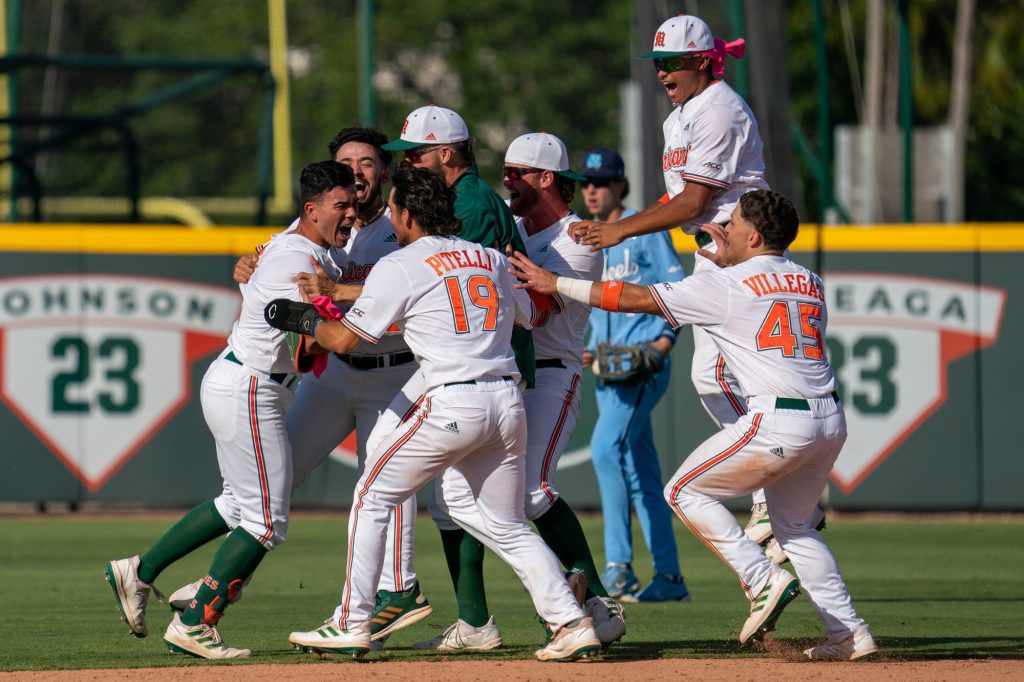 Canes baseball players celebrate after freshman outfield/infielder Renzo Gonzalez’s walk off single RBI, earning the Canes a 3-2 victory over the Tarheels, in the bottom of the 14th inning of Miami’s game versus the University of North Carolina at Chapel Hill at Mark Light Field on March 27, 2022.