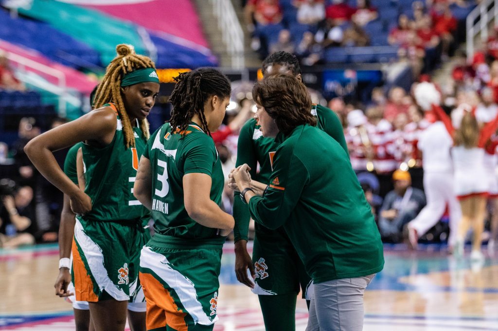 Head coach Katie Meier talks with her players in Miami's 60-47 loss to No. 3 NC State in the ACC Tournament championship game on Sunday, March 6, 2022 at the Greensboro Coliseum in Greensboro, North Carolina.