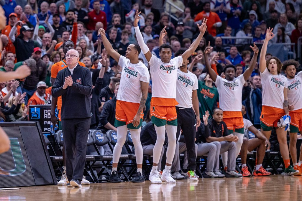 Miami's bench celebrates after a three point shot during the first half of Miami's Elite Eight matchup against Kansas at the United Center in Chicago on Sunday, March 27, 2022. Miami led Kansas by six points at the end of the first half.