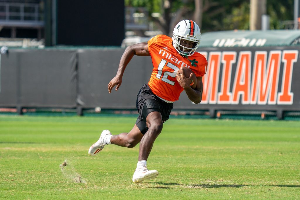 Sophomore wide receiver Brashard Smith runs after catching a ball during drills at the Greentree Practice Fields on March 11, 2022.