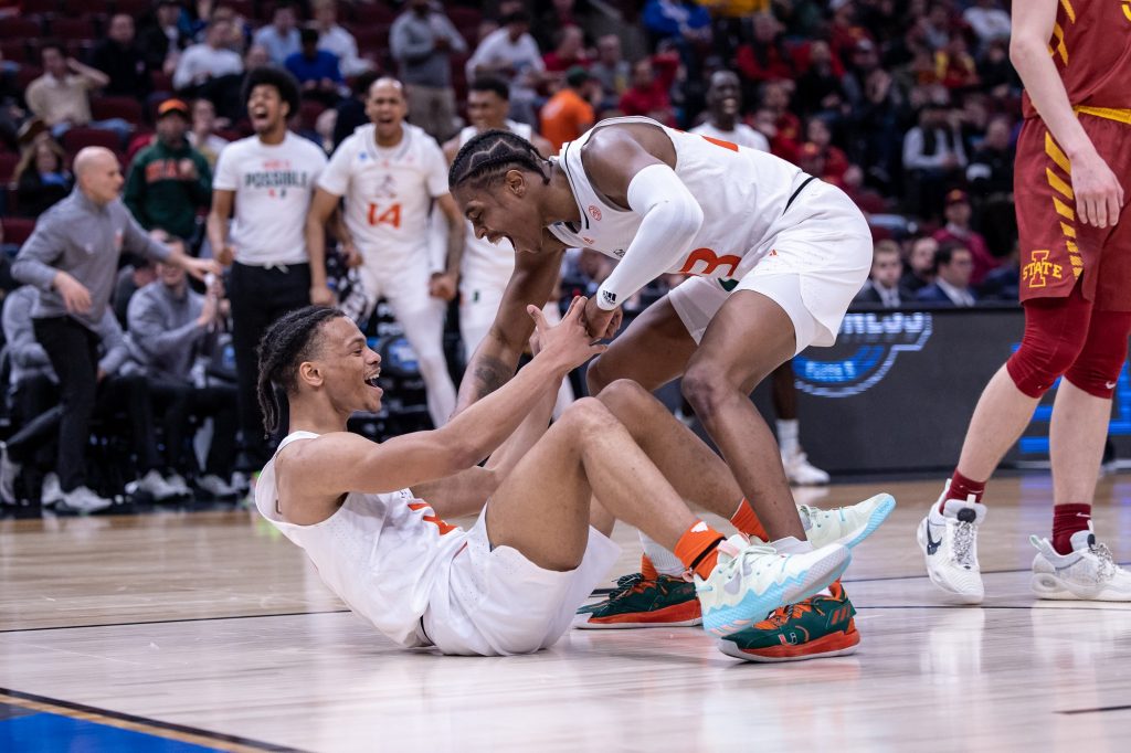 Sixth-year redshirt senior Kameron McGusty celebrates with third-year sophomore Isaiah Wong after Wong makes a shot and gets fouled during Miami's Sweet 16 matchup against Iowa State at the United Center in Chicago, Illinois on Friday, March 25, 2022. Wong scored all seven of his points in the second half.
