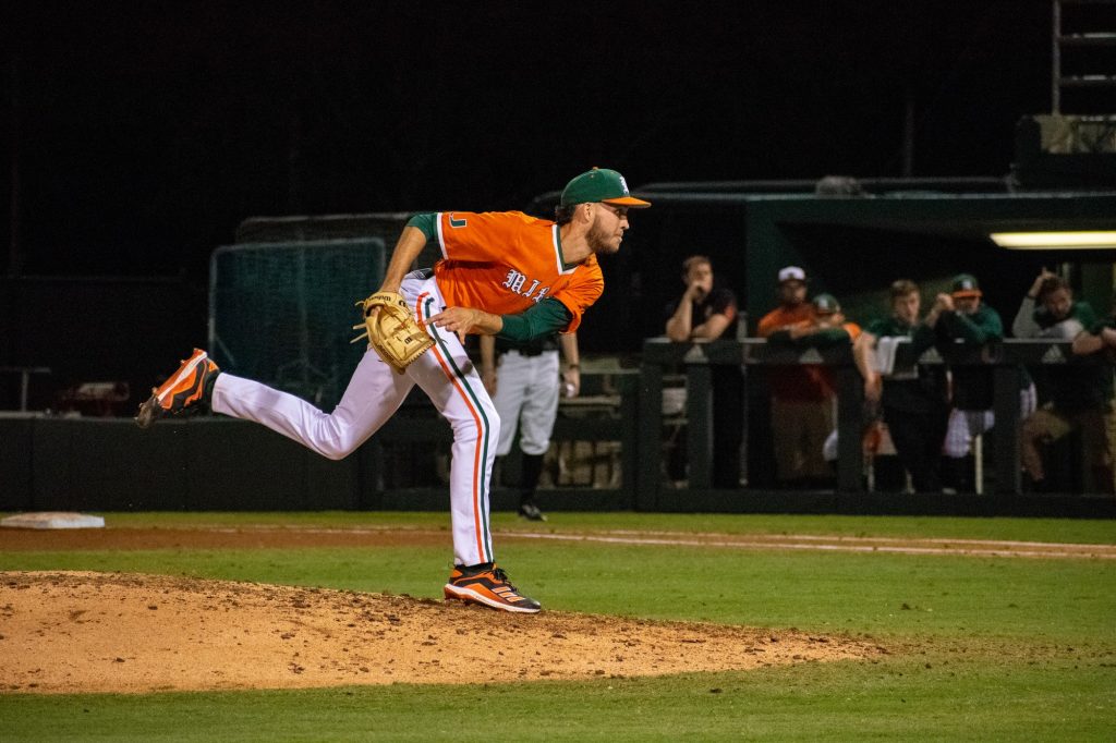 Sophomore left-handed pitcher Carson Palmquist throws a pitch during the opening innings of Miami's game against Harvard on Saturday, Feb. 26, 2022 at Mark Light Field.