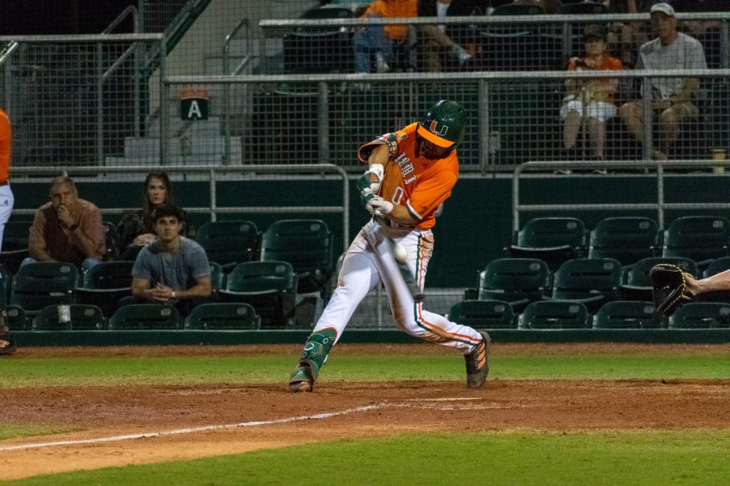 Freshman infielder Dorian Gonzalez Jr. makes a hit in the bottom of the seventh during Miami's bounce-back win against Harvard on Saturday, Feb. 26, 2022 at Mark Light Field.