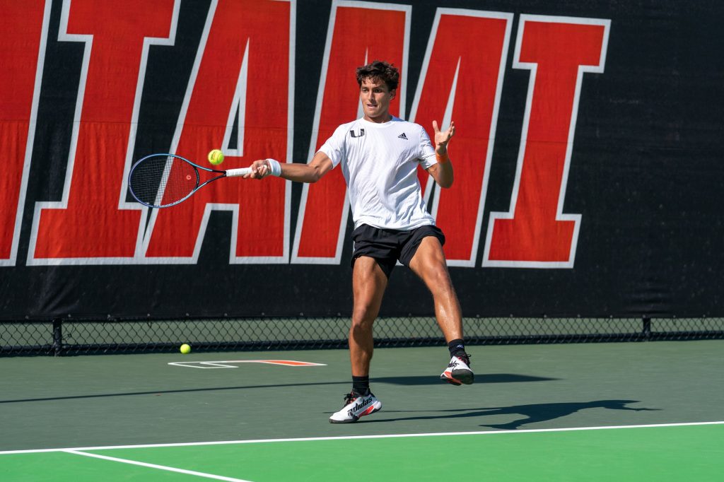 Fourth-year junior Franco Aubone returns the ball during the second match of the second set of his singles match versus Seminole redshirt freshman John Bernard at the Neil Schiff Tennis Center on March 30, 2022.