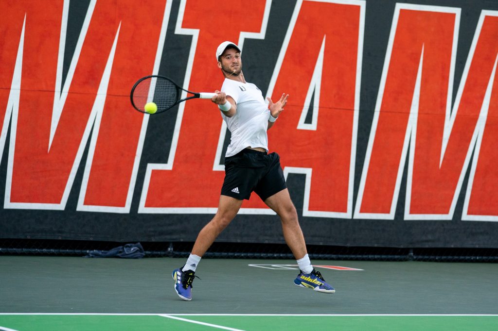 Graduate student Dan Martin returns the ball during the seventh game of the first set of his singles match versus senior Brian Cernoch at the Neil Schiff Tennis Center on March 11, 2022.