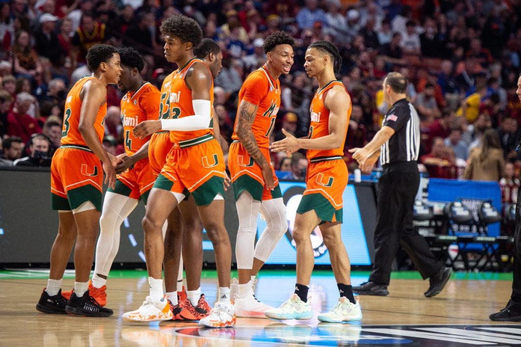 Miami returns to its bench during the first half of UM's 68-66 win over Southern California on Friday, March 18, 2022 at Bon Secours Wellness Arena in Greenville, South Carolina.
