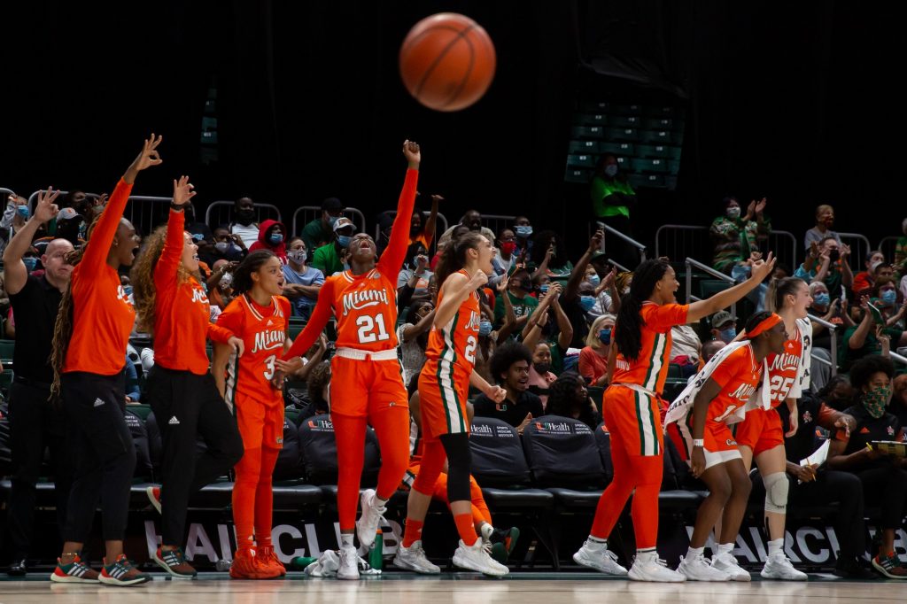 The Miami bench celebrates after a point in the fourth quarter of their game versus Clemson in The Watsco Center on Feb. 27, 2022.