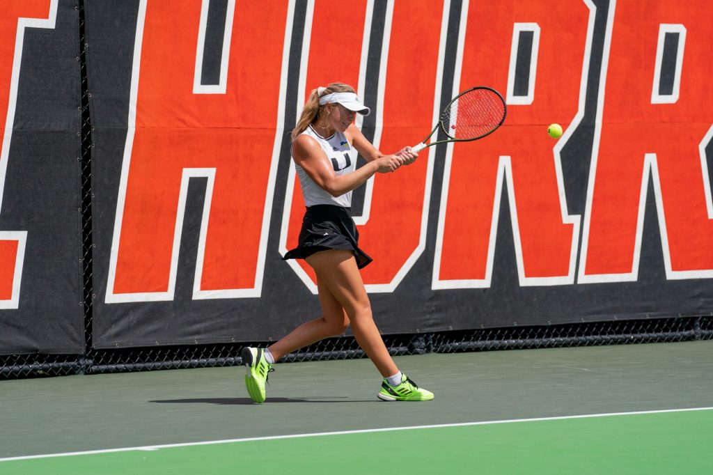 Fifth-year senior Eden Richardson returns the ball during the third game of the first set of her singles match versus Clemson sophomore Cristina Mayorova at the Neil Schiff Tennis Center on Feb. 27, 2022.