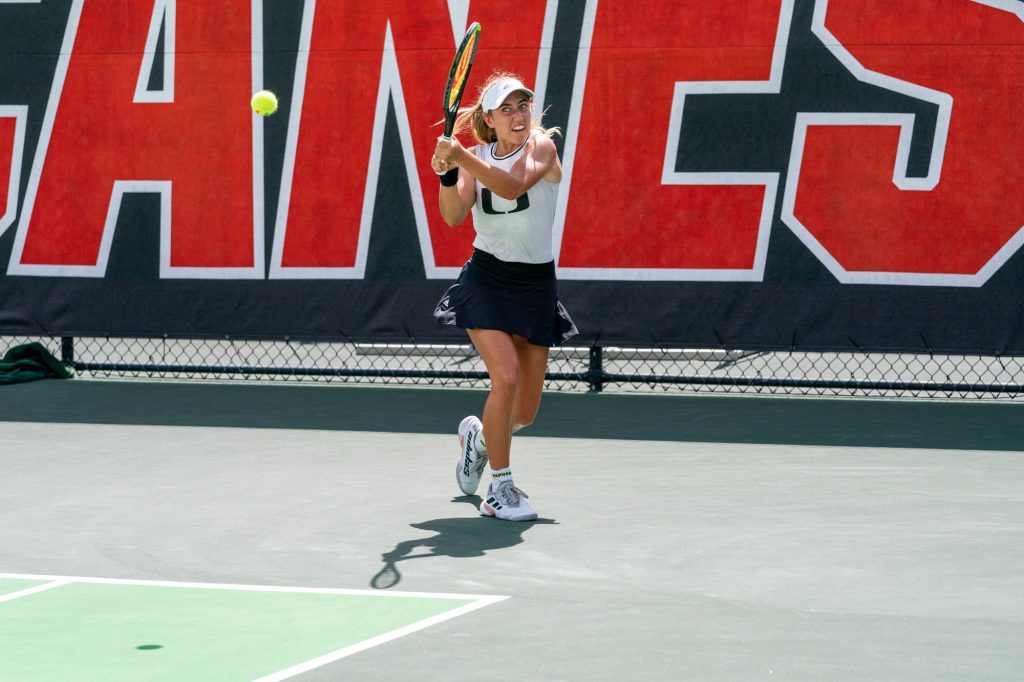 Sophomore Isabella Pfennig returns the ball during the third game of the first set of her singles match versus Clemson sophomore Jenna Thompson at the Neil Schiff Tennis Center on Feb. 27, 2022.